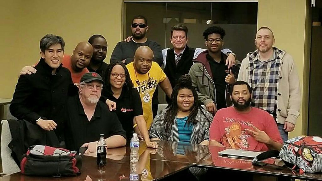 Photo of twelve members of the Universal Fan Con organizing team.